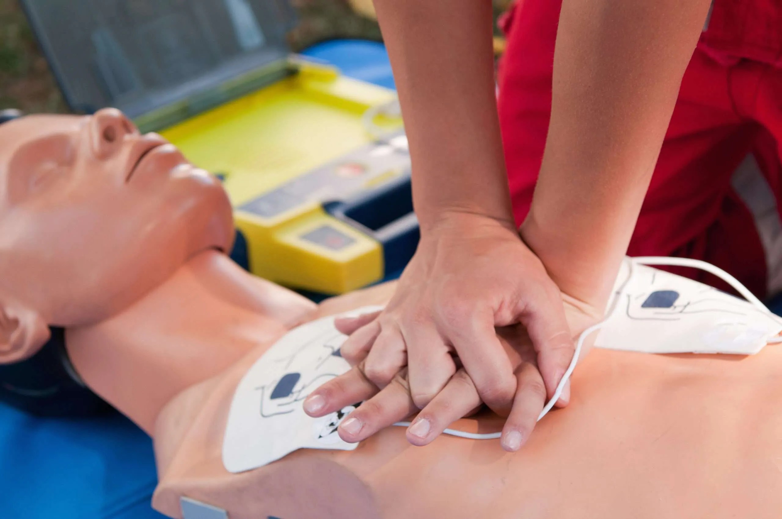 Practicing defibrillator CPR procedure on a dummy Practicing defibrillator CPR procedure on a dummy